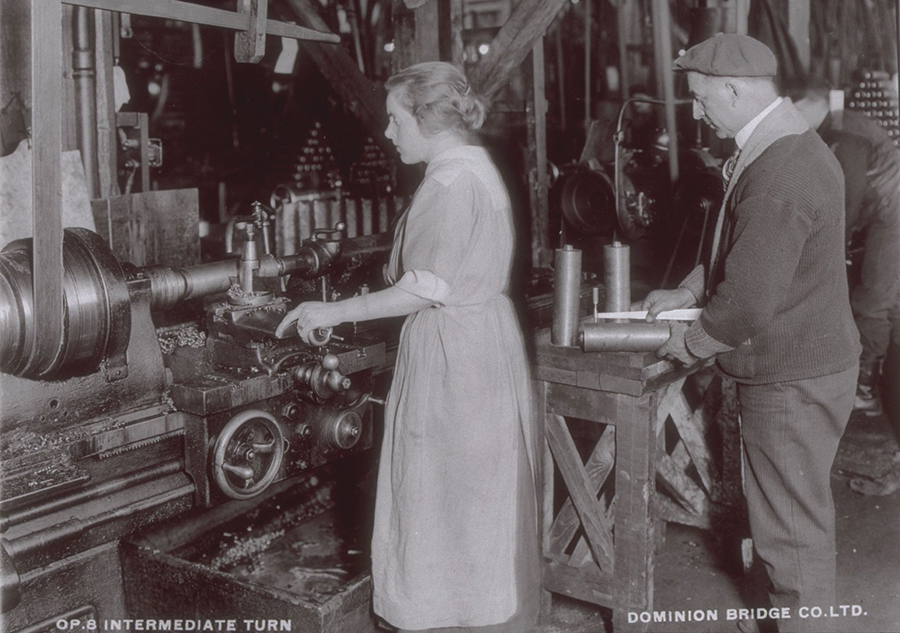Femme qui manipule des obus dans une usine
