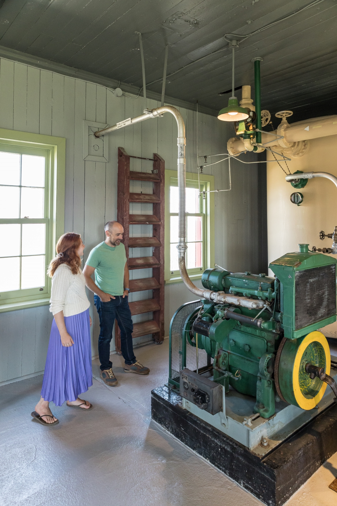 A couple examine a machine used to activate the foghorn.