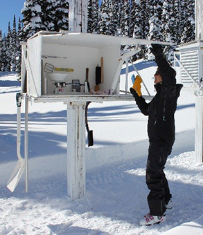 Parks Canada staff opening the Stevenson screen weather station.