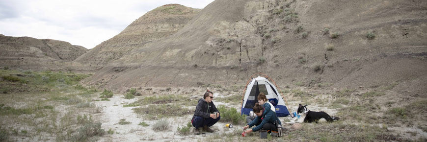 Millennials and their dog, camp at the Valley of 1,000 Devils at Grasslands National Park.